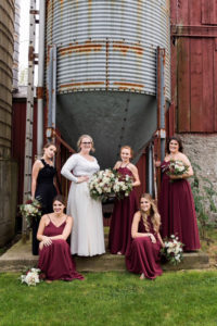 The bride and her bridesmaids in the barn