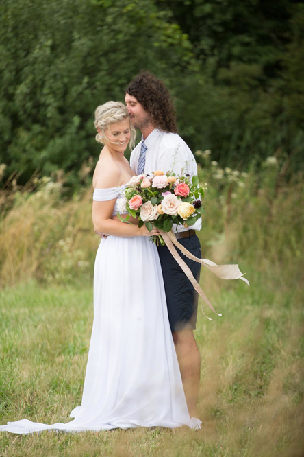 The bride holding her bouquet of garden roses