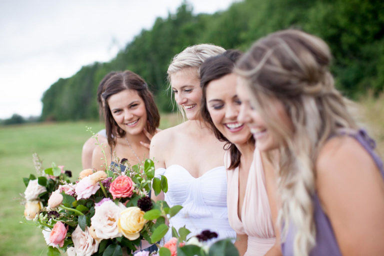 The bride laughing with her bridesmaids