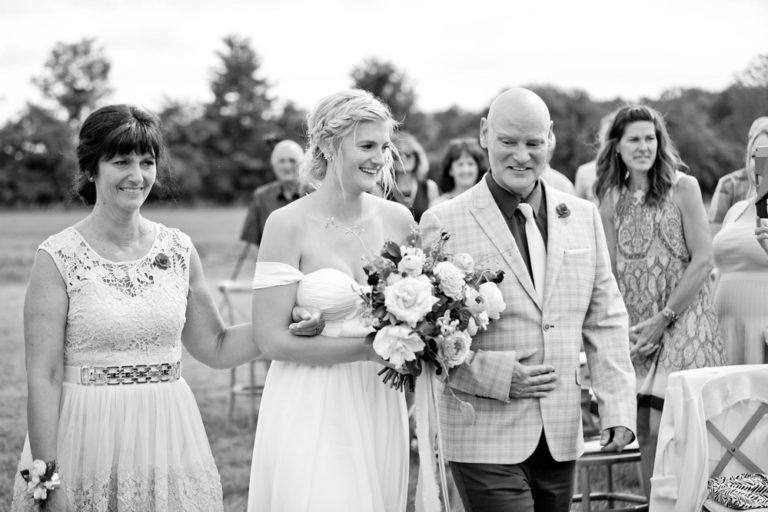 Black-and-white photo of the bride hugging a guest