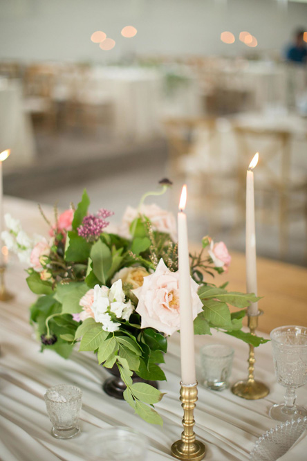 A candle and flowers on the table