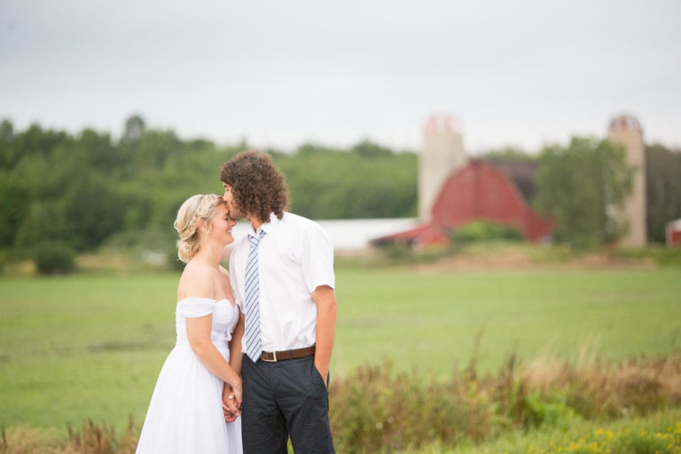 Shanayde and Dylan in the field with the red barn behind them